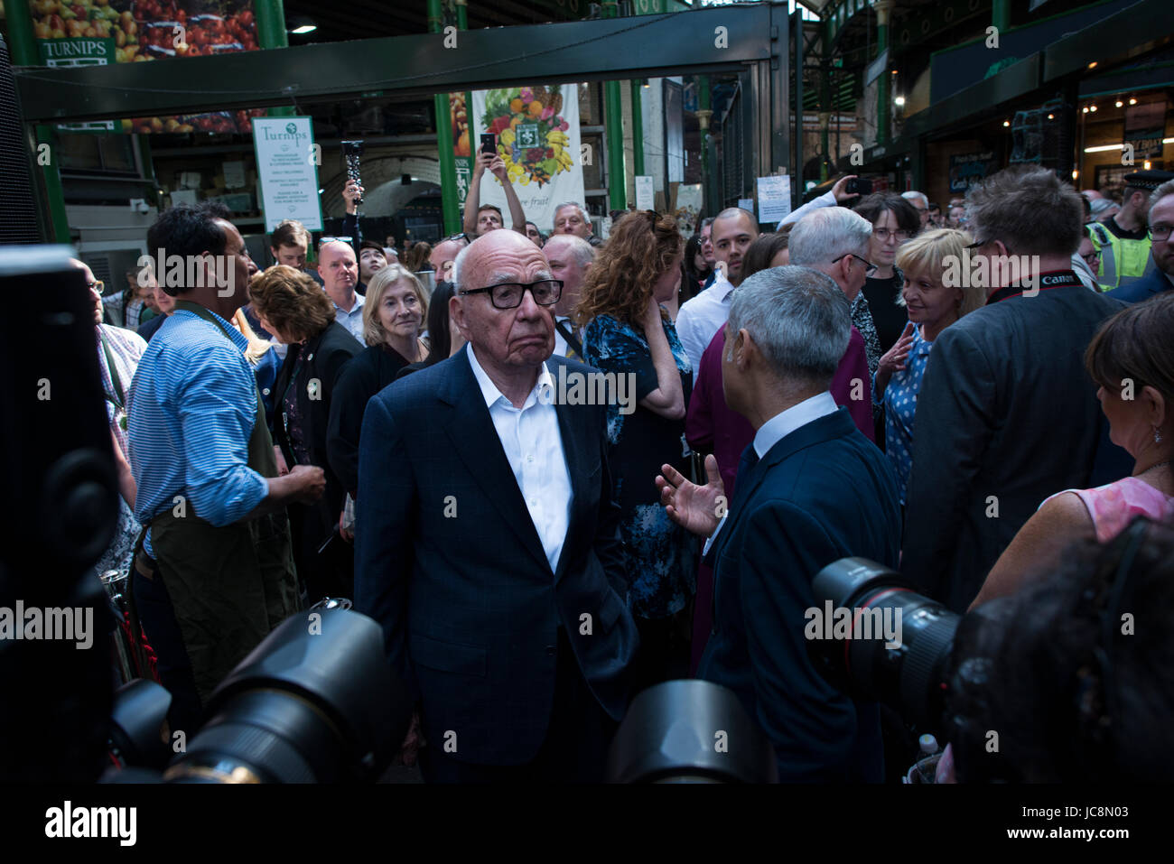 Borough Market, London, UK. 14th Apr, 2017. Borough Market has officially re-opened, following last weeks terrorist attack, which left 8 people dead and 48 injured within the vicinity. In picture, A distant looking Rupert Murdoch speaks with London Mayor Sadiq Khan. Credit: Byron Kirk/Alamy Live News Stock Photo