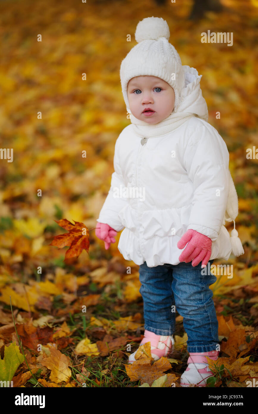 happy little girl in autumn park Stock Photo - Alamy
