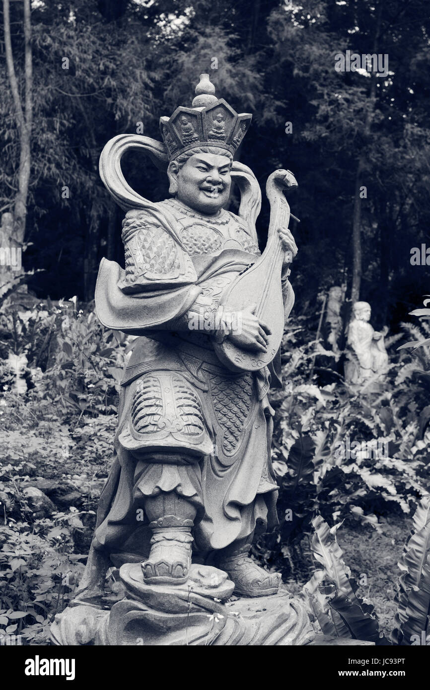Aged asian god stone statue Stock Photo Alamy