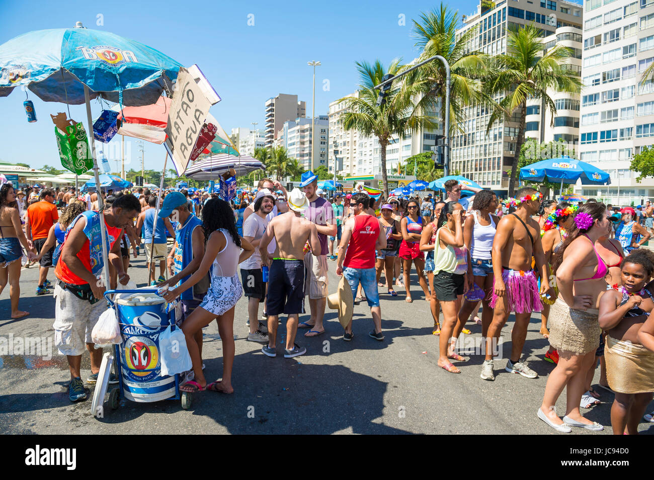 RIO DE JANEIRO - FEBRUARY 19, 2017: Crowds of young people and vendors gather at a morning street party in Copacabana during the city's carnival celeb Stock Photo