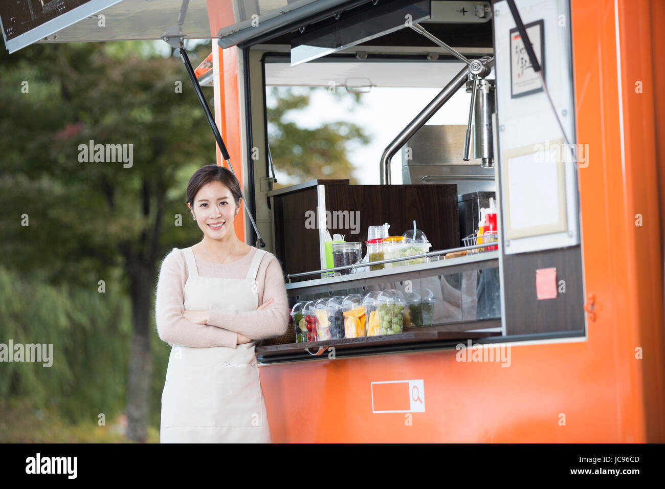 Young smiling vendor at food truck Stock Photo - Alamy