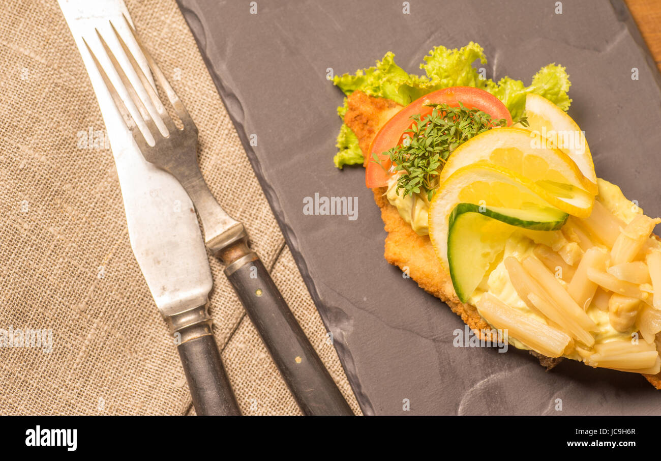Danish specialties and national dishes, high-quality open sandwich, served on a plate ready for eating. fish fillet and garnished with remoulade and l Stock Photo