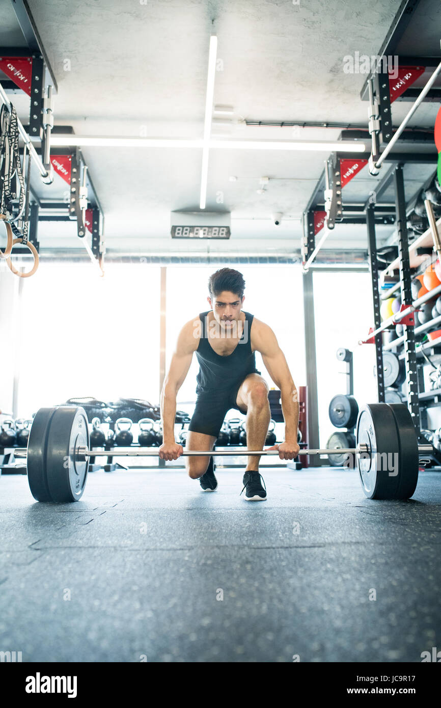 Young fit hispanic man in gym lifting heavy barbell Stock Photo - Alamy