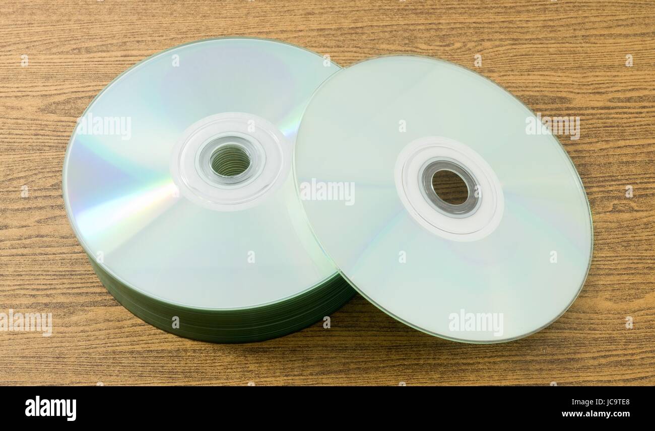 A Stack of CD or DVD Compact Disc on A Wooden Table. Stock Photo