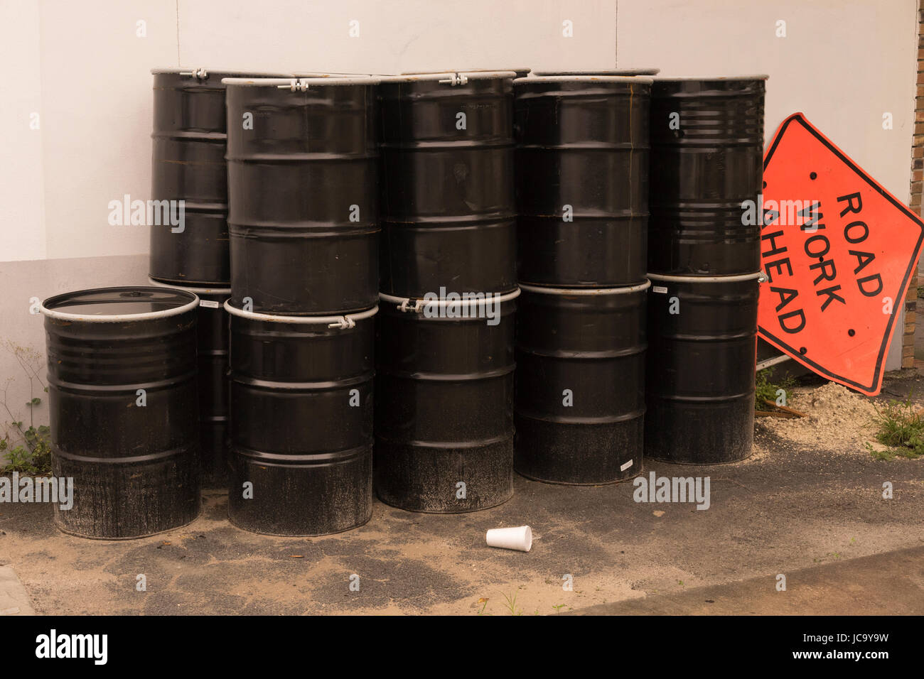 Large Black Waste Barrels Stacked Up Stock Photo