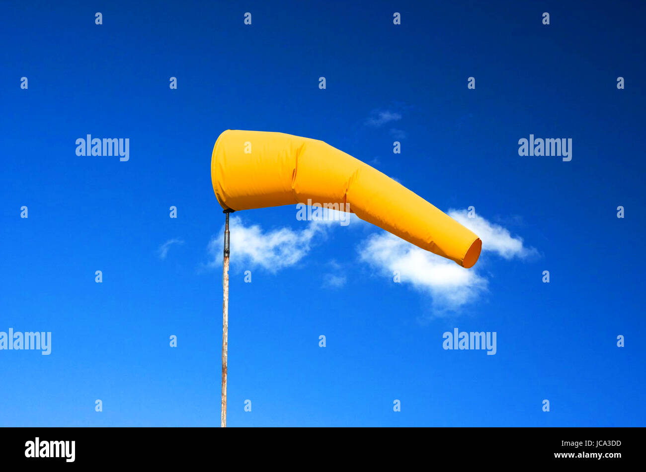 Gelbe Wetterfahne, Windsack, Windrichtungs Anzeige vor einem blauen Himmel. Stock Photo