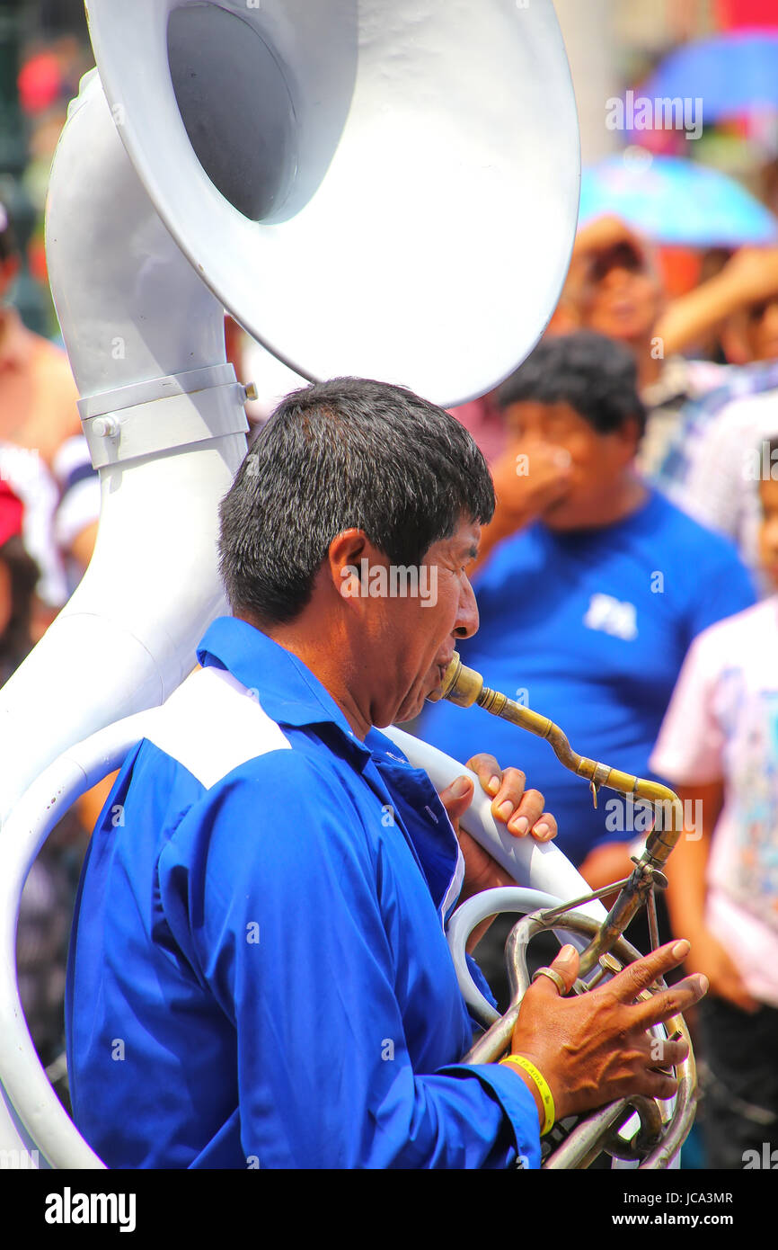 Local man playing sousaphone during Festival of the Virgin de la Candelaria in Lima, Peru. The core of the festival is dancing and music performed by  Stock Photo