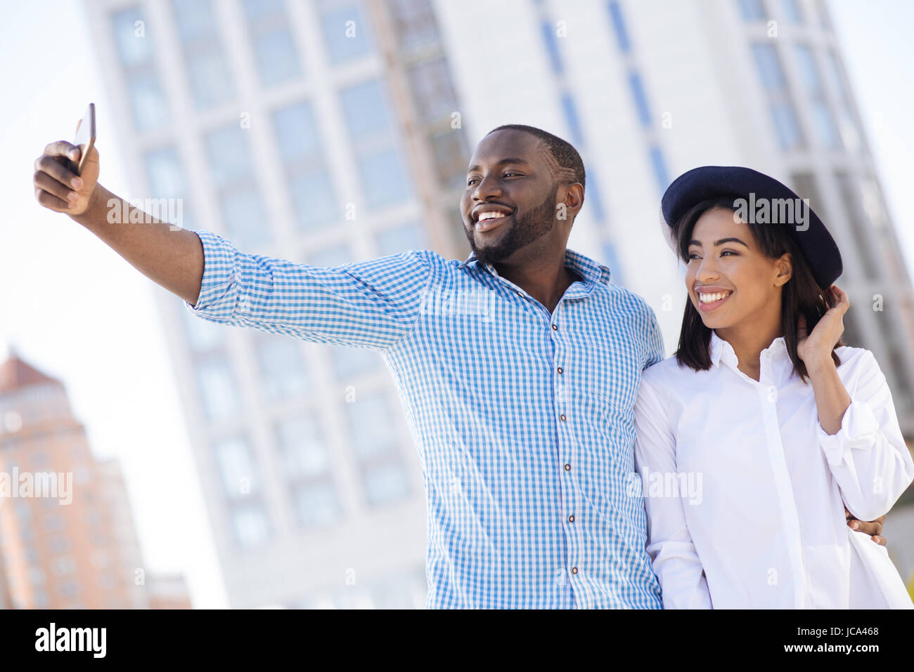 Beautiful happy modern couple posing for a selfie Stock Photo - Alamy