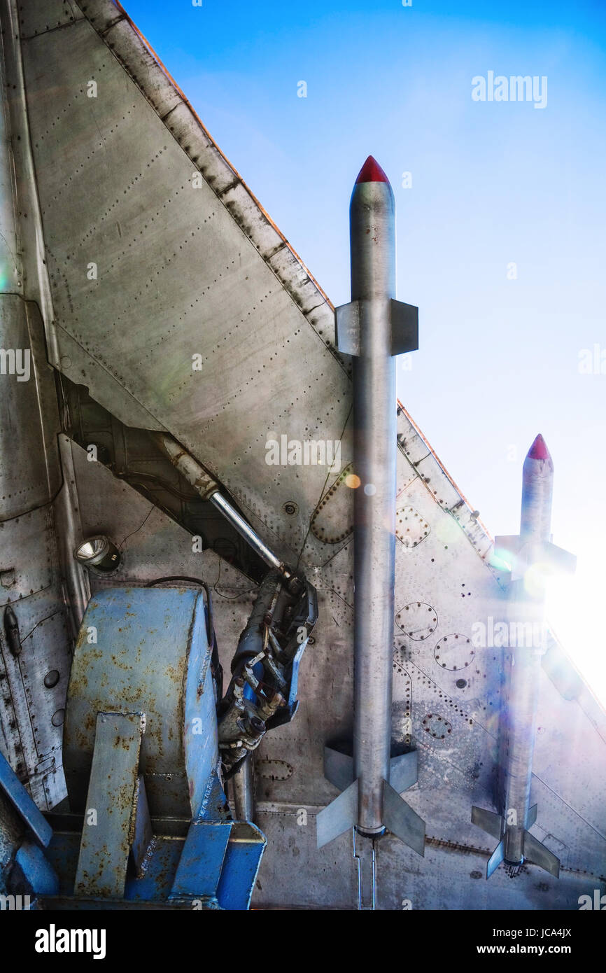 War-plane wing with missiles at sunlight. Bottom view. Stock Photo