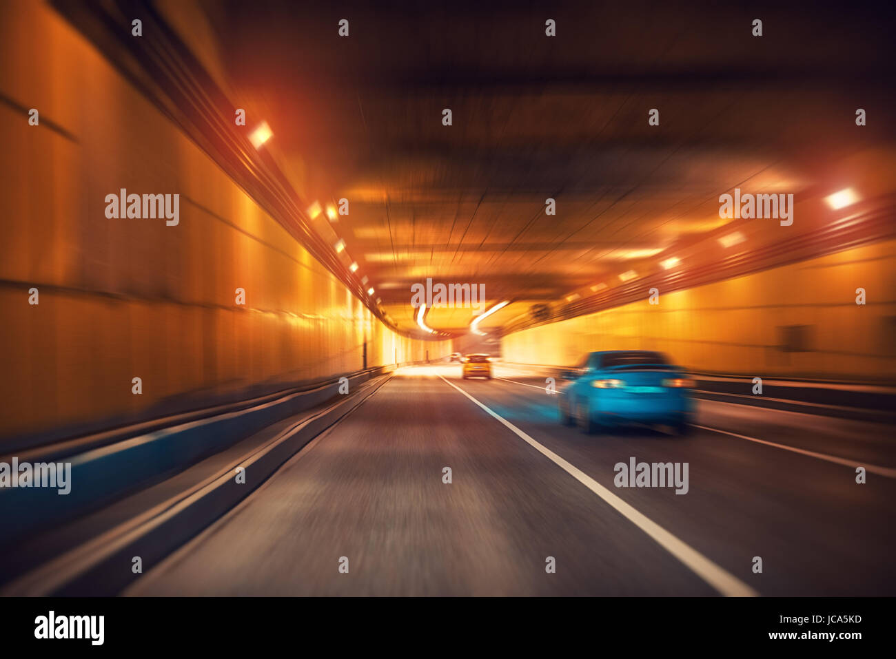 Underground modern highway tunnel with several cars. Fast blurred motion effect. Stock Photo