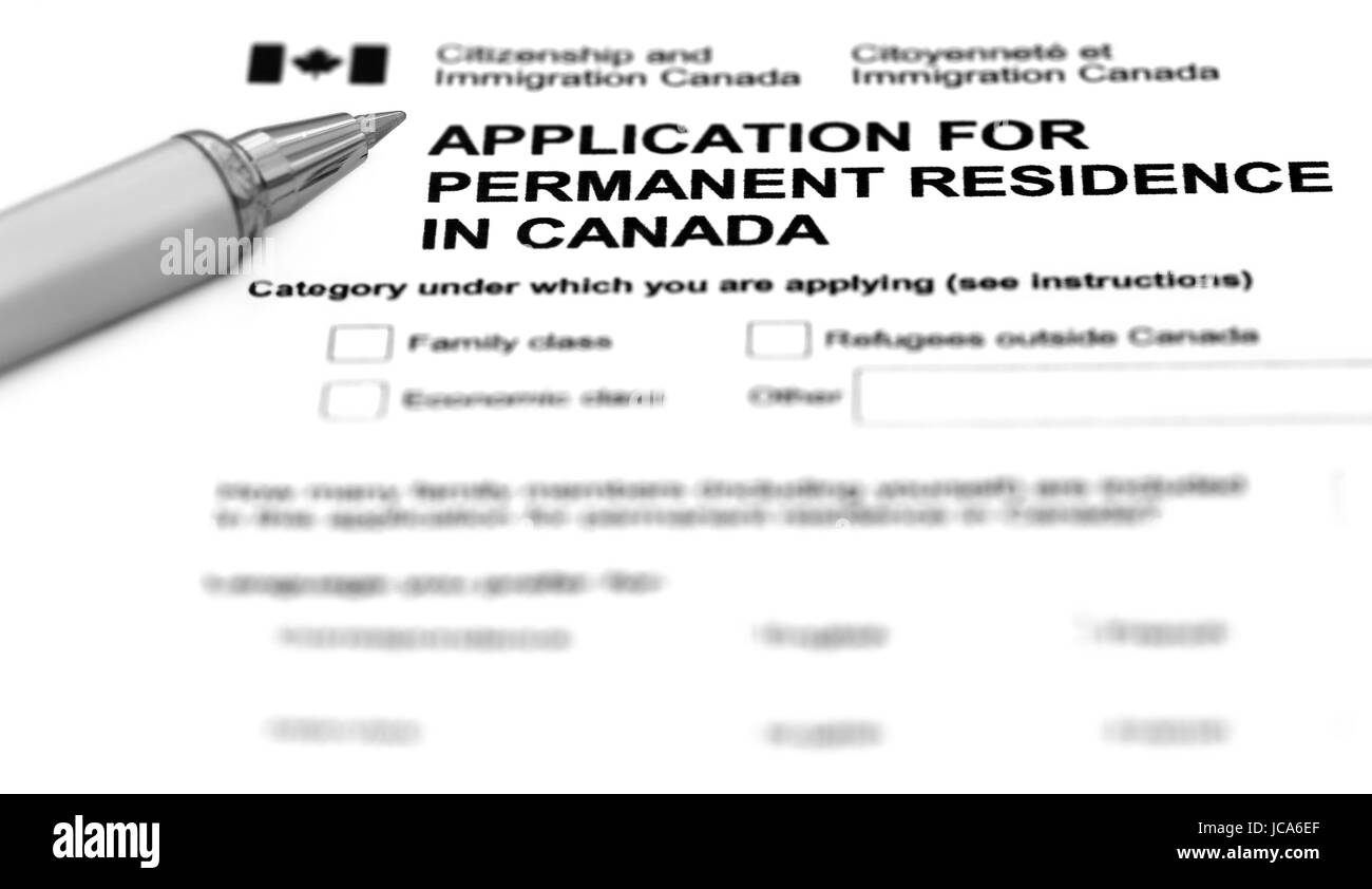 Visa application form filling with silver ballpoint Stock Photo