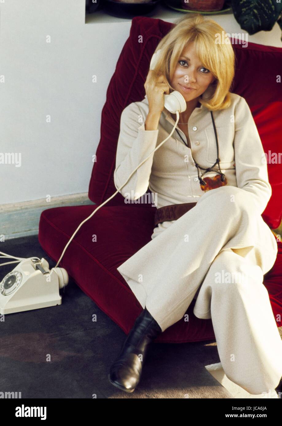 French actress Mireille Darc at home in her appartment in the 16th arrondissement of Paris, 1971.  She wears an outfit designed by Yves Saint-Laurent. Photo Michael Holtz Stock Photo
