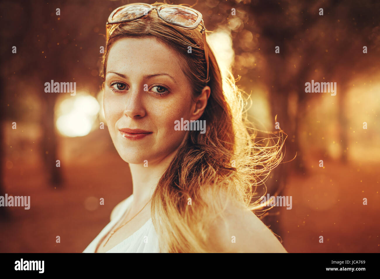 Young blond woman with sunglasses portrait at sunset light Stock Photo