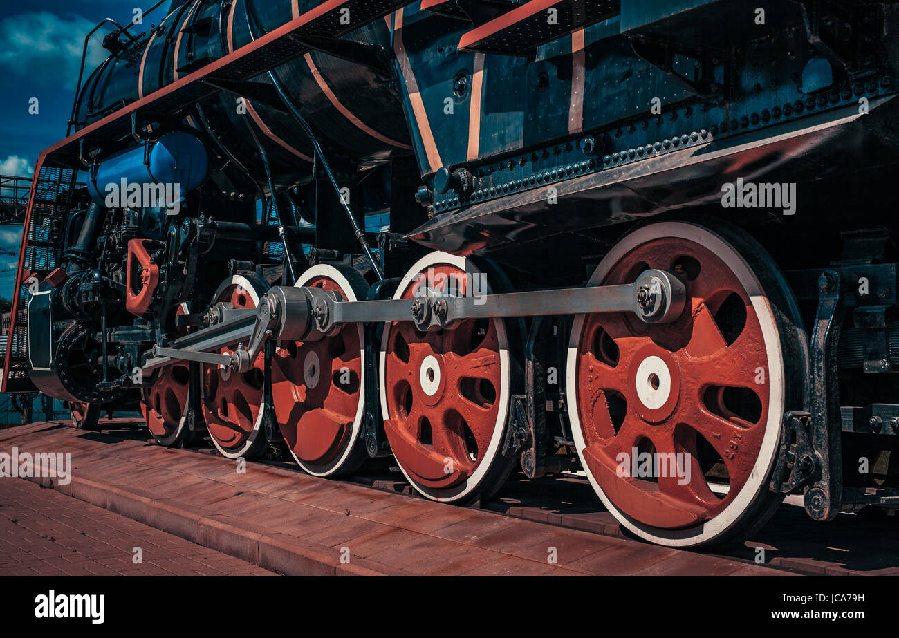 Vintage train close-up wheels view. Blue and red color tinting. Stock Photo