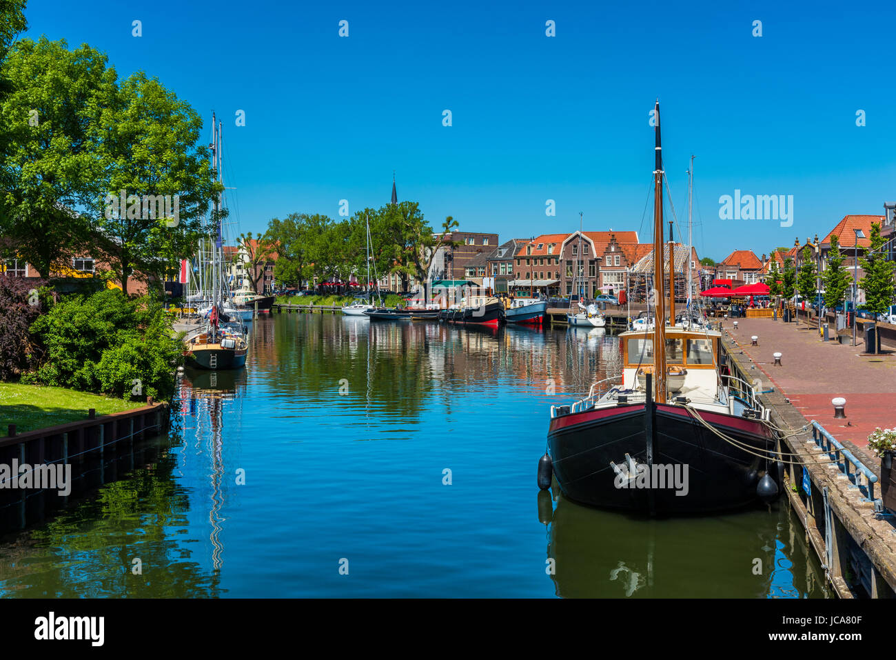 Ships in Canal in City Center of Enkhuizen Netherlands Stock Photo