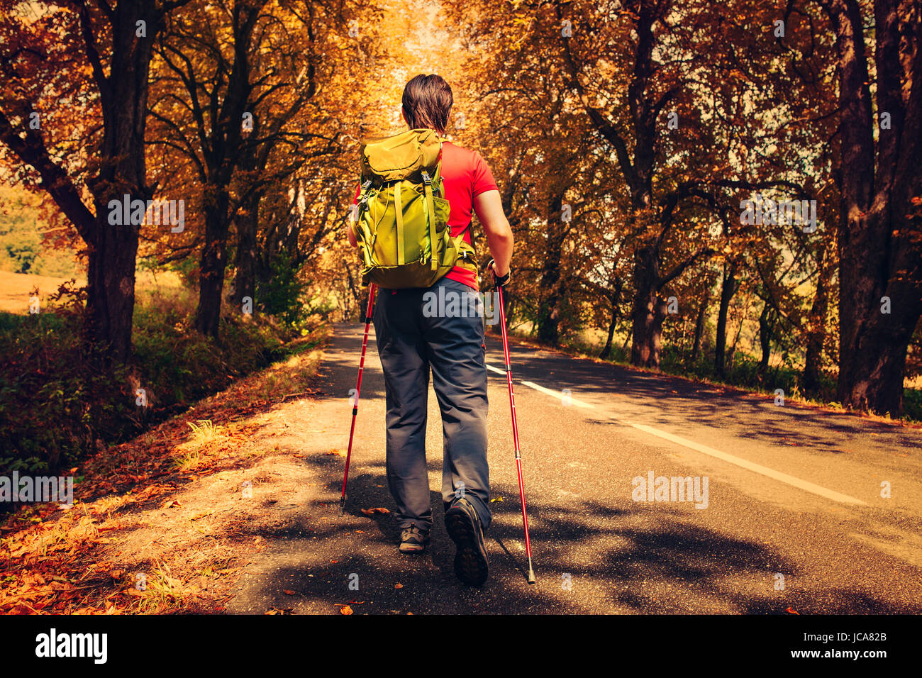 Young man walking on road hi-res stock photography and images - Alamy
