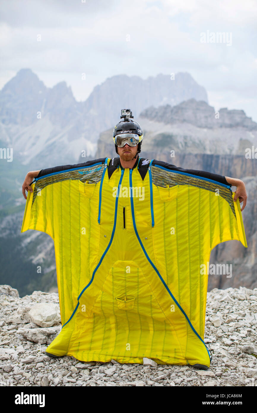 Portrait of BASE jumper with his wings spread, just before taking flight in the Sass Pordoi region of the Dolomites in Northeastern Italy. Stock Photo