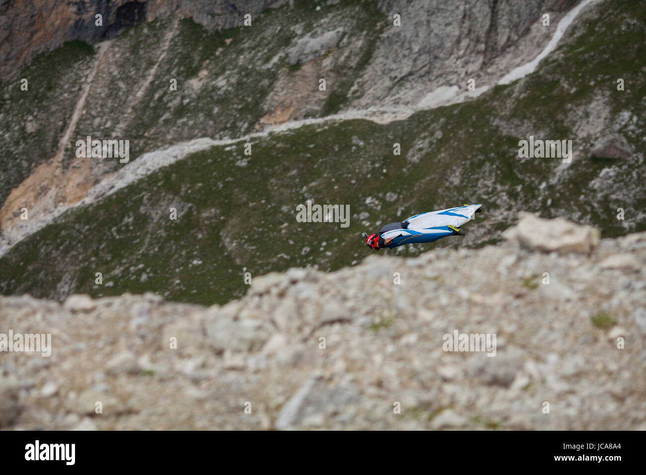 Wingsuit pilot Hartman Rector soars by in the Dolomites. Italy. Stock Photo