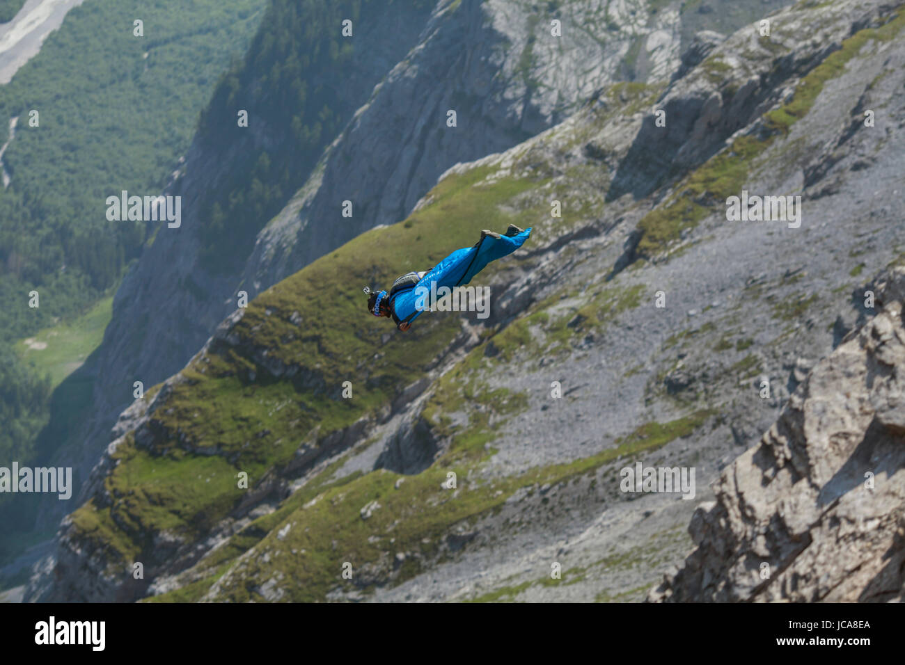 A wing suit pilot flying in the Swiss Alps.  Lauterbrunnen, Switzerland. Stock Photo