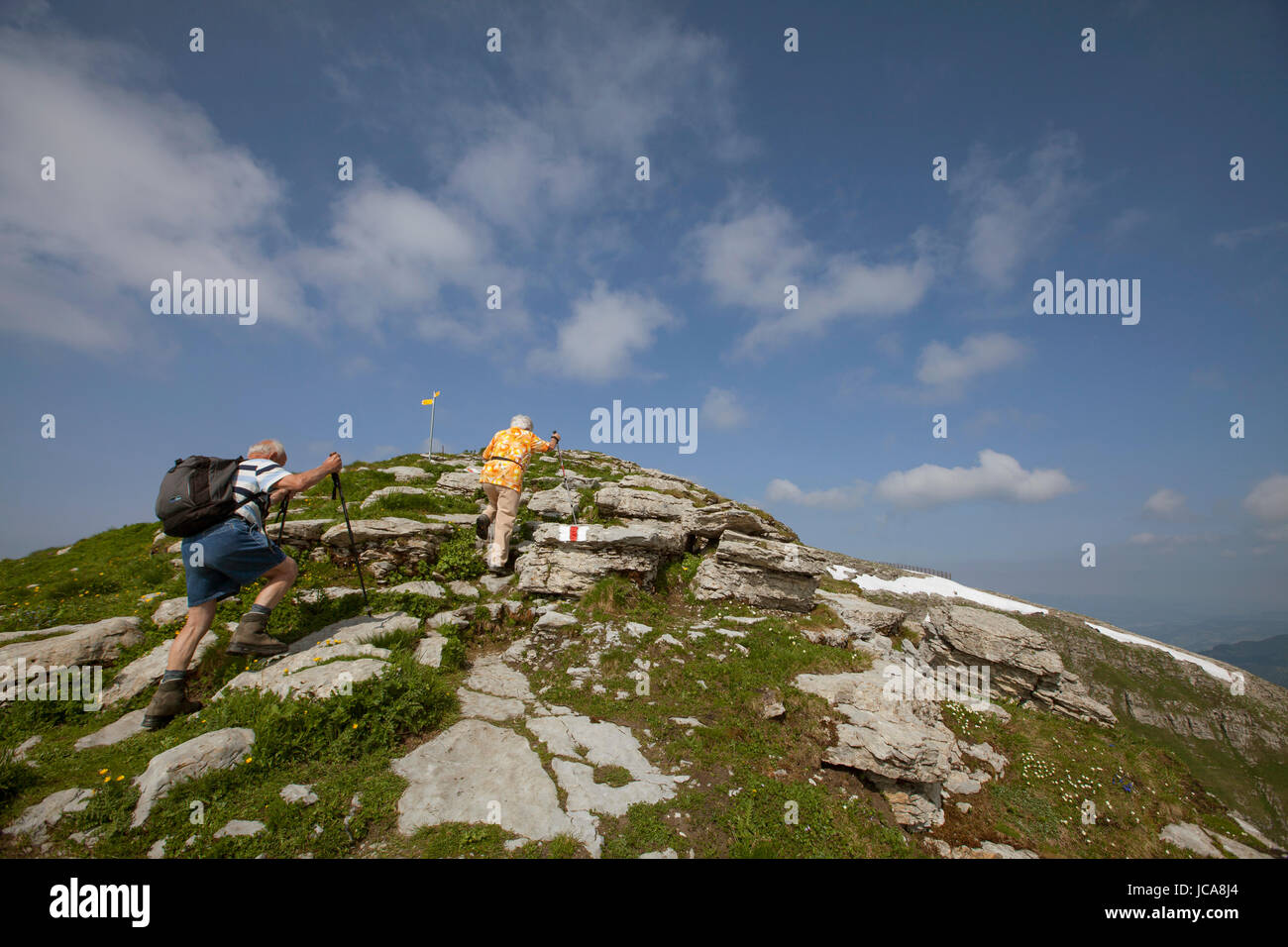 An unidentified couple hiking in the Toggenburg region of the Swiss Alps far above Lake Wallen. Stock Photo