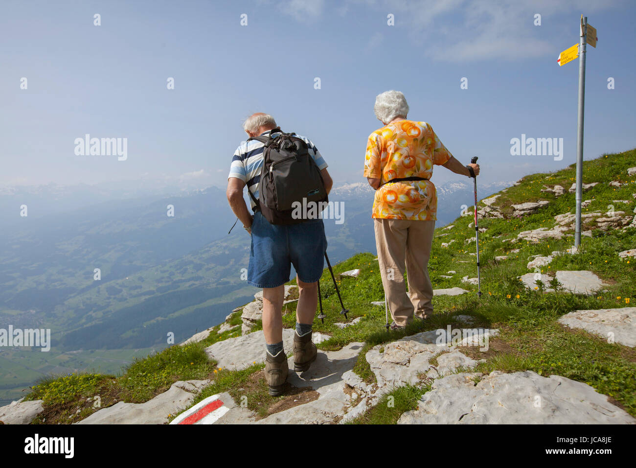 An unidentified couple hiking in the Toggenburg region of the Swiss Alps far above Lake Wallen. Stock Photo