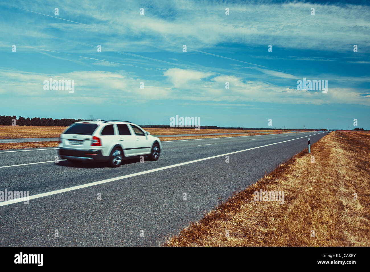 Car travel on europe road. Blue sky and summer field panorama. Stock Photo