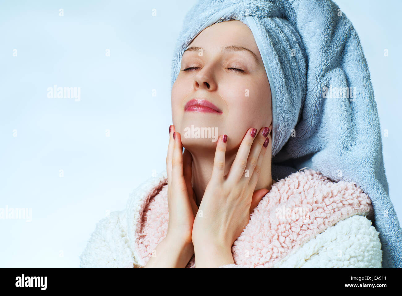 Young woman with bathrobe and towel. Beauty spa portrait. Stock Photo