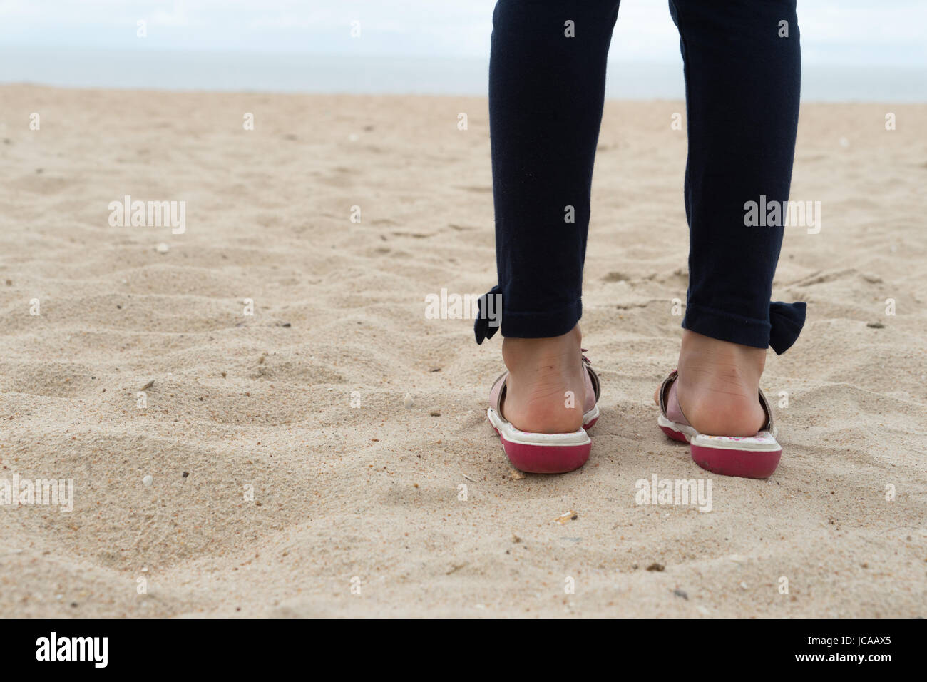 girl child standing face ocean beach Stock Photo