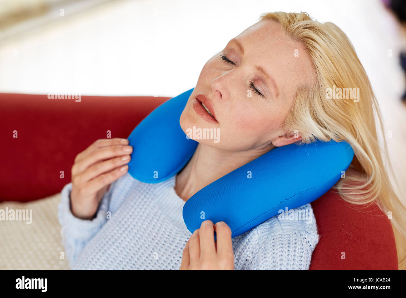 Woman wearing neck cushion Stock Photo