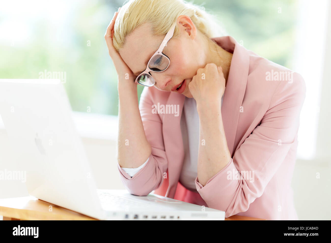 Stressed woman at work Stock Photo