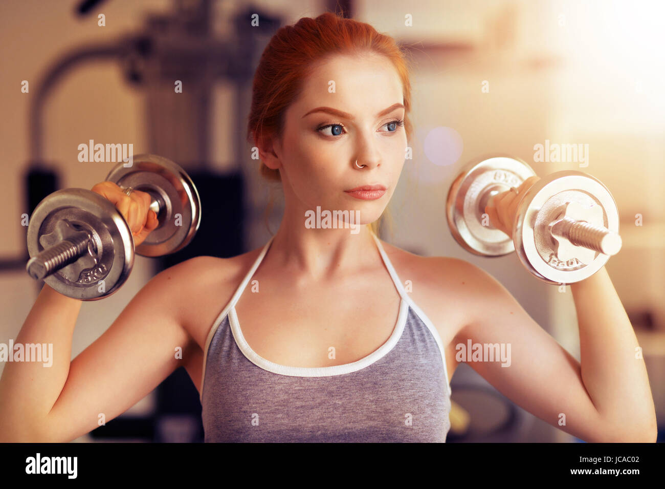 Portrait of a sporty young woman training in gym Stock Photo - Alamy