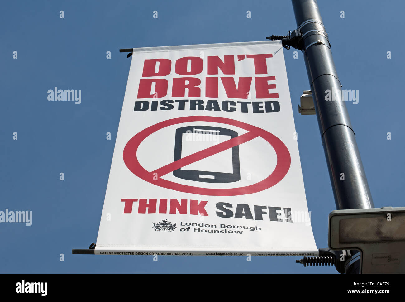 don't drive distracted think safe! hounslow council road safety banner advising drivers not use mobile phones while driving Stock Photo