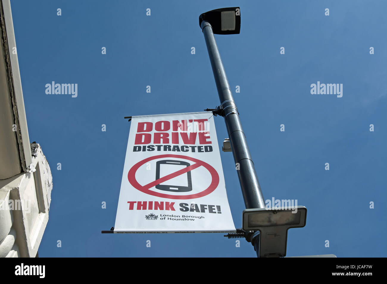 don't drive distracted think safe! hounslow council road safety banner advising drivers not use mobile phones while driving Stock Photo