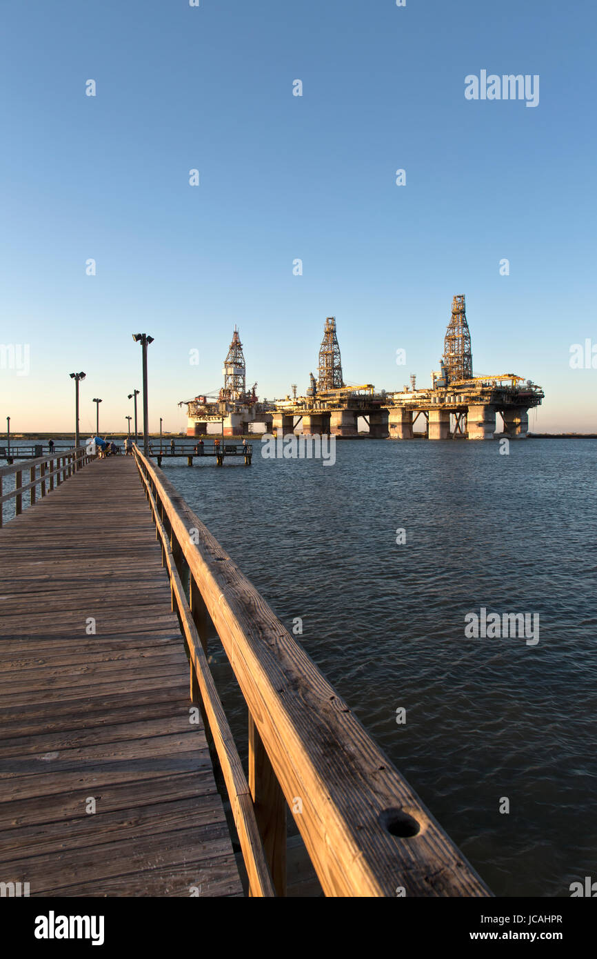 Deepwater drill rigs temporarily in storage, fishing pier. Stock Photo