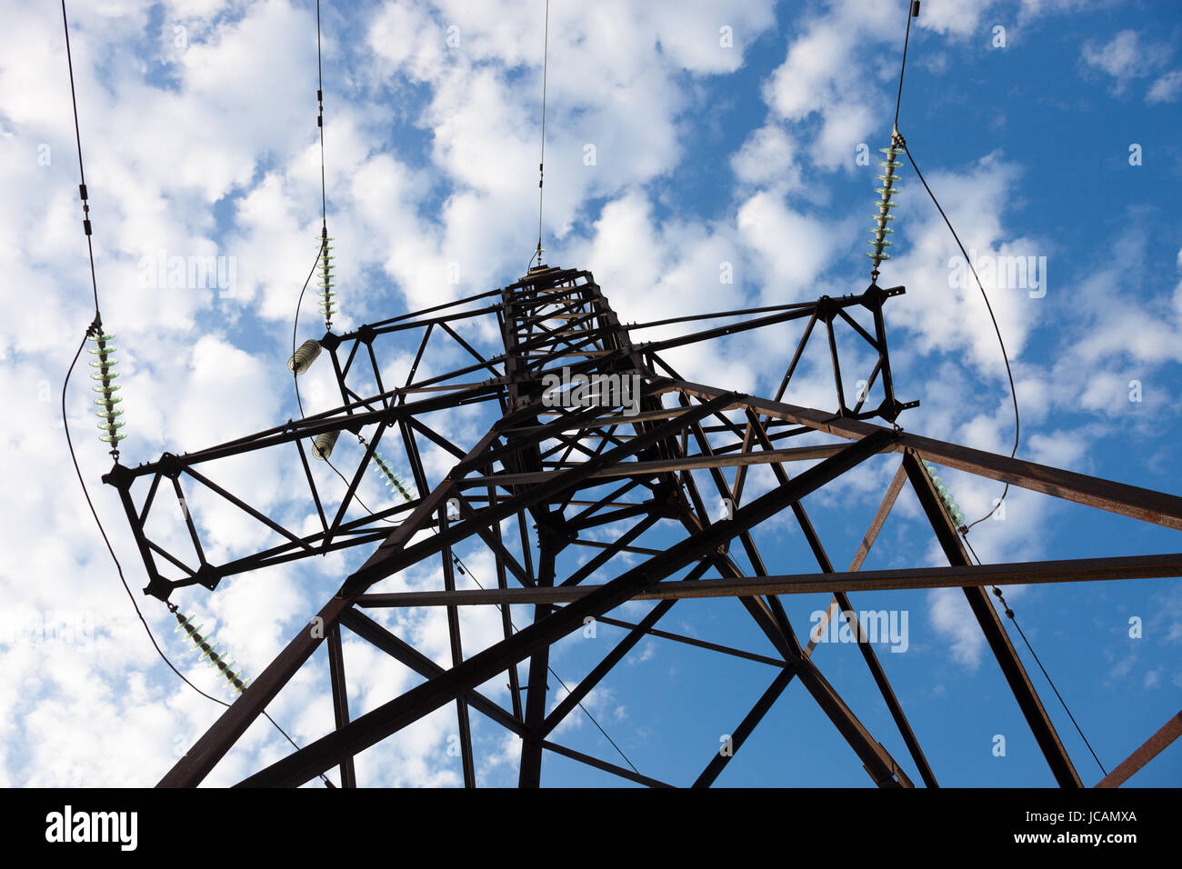Electricity pylon against the cloudy sky background Stock Photo - Alamy