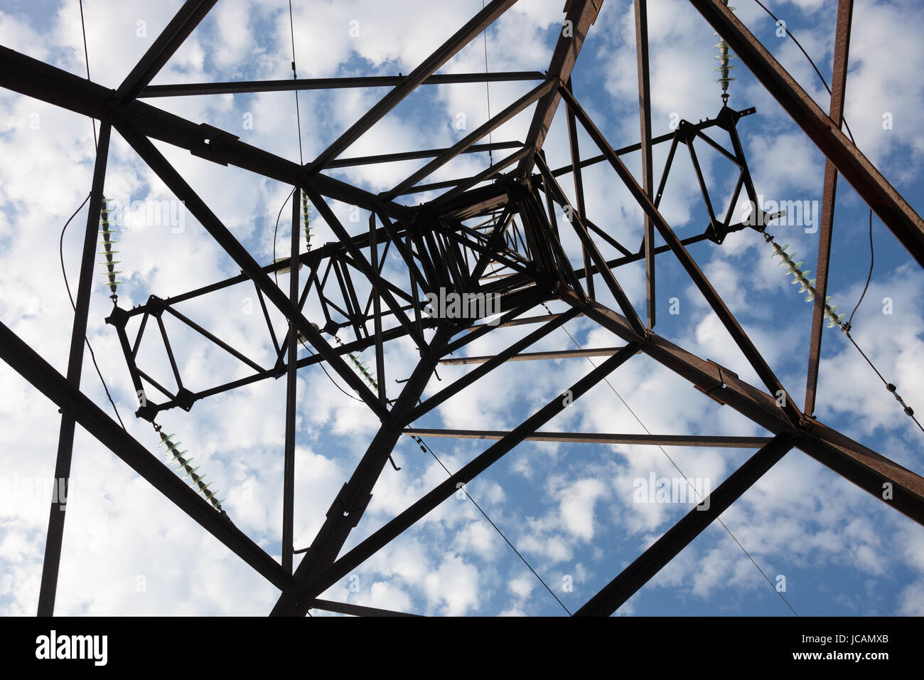 Electricity pylon against the cloudy sky background Stock Photo - Alamy