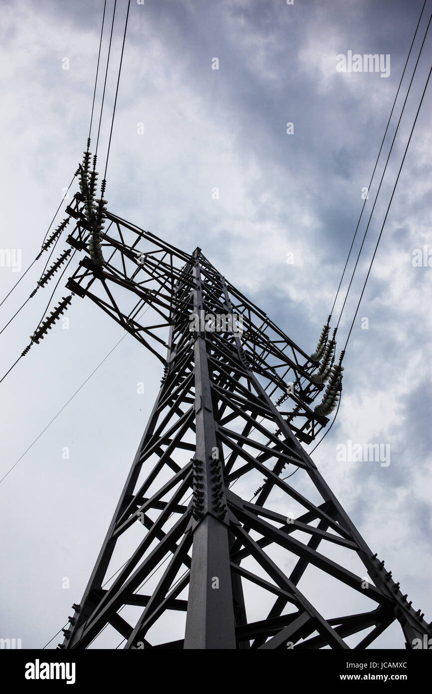 Electricity pylon against the cloudy sky background Stock Photo - Alamy