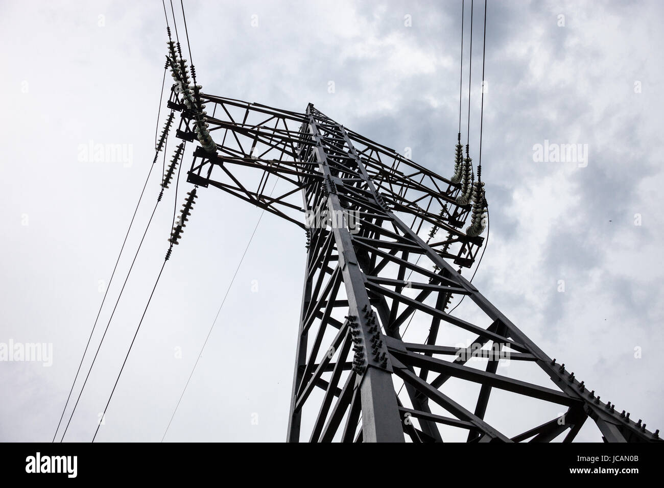 Electricity pylon against the cloudy sky background Stock Photo - Alamy