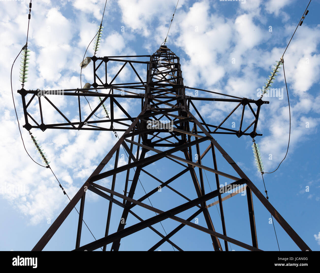 Electricity pylon against the cloudy sky background Stock Photo - Alamy