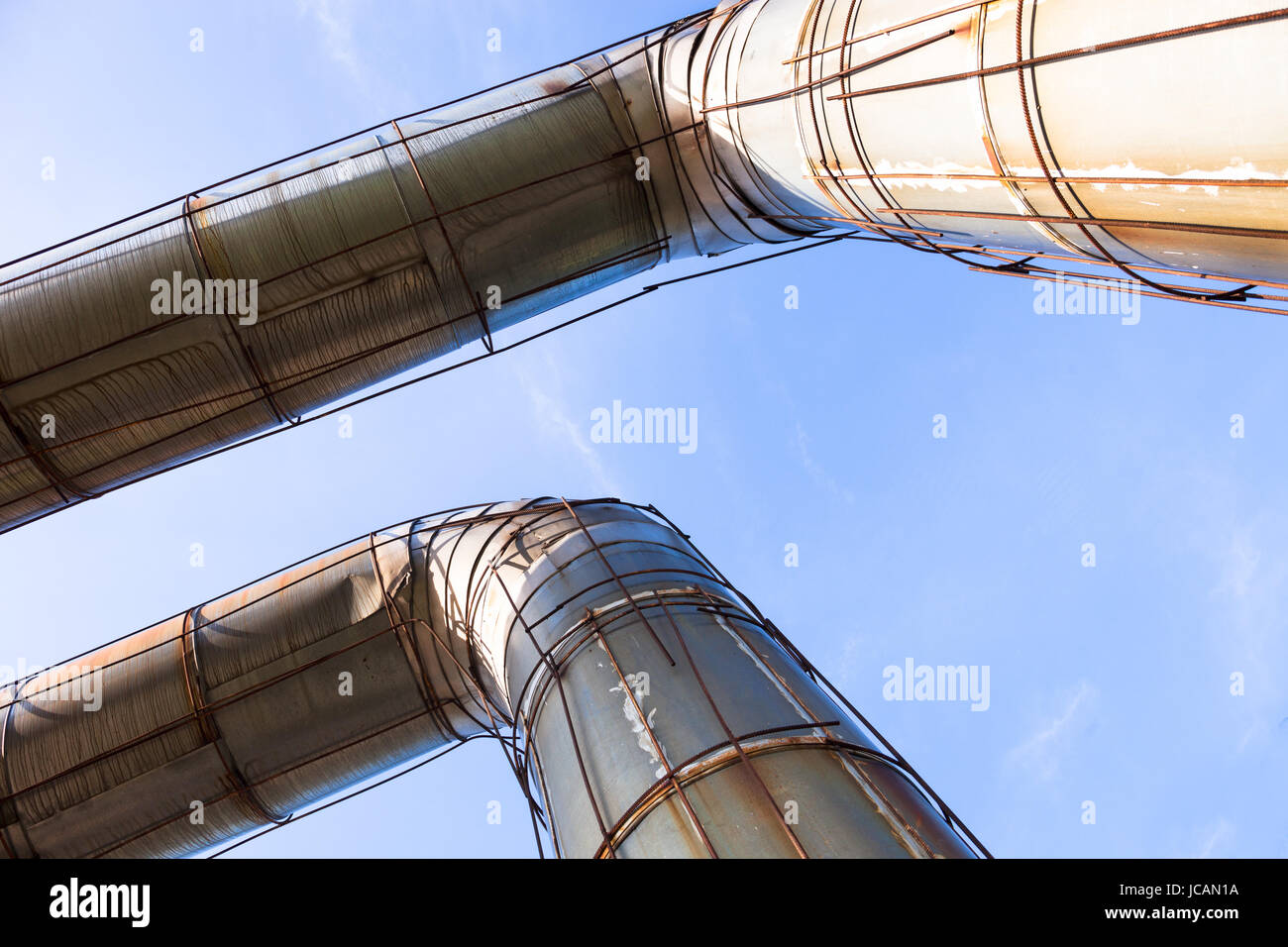 Elevated section of the pipelines against the blue sky Stock Photo - Alamy