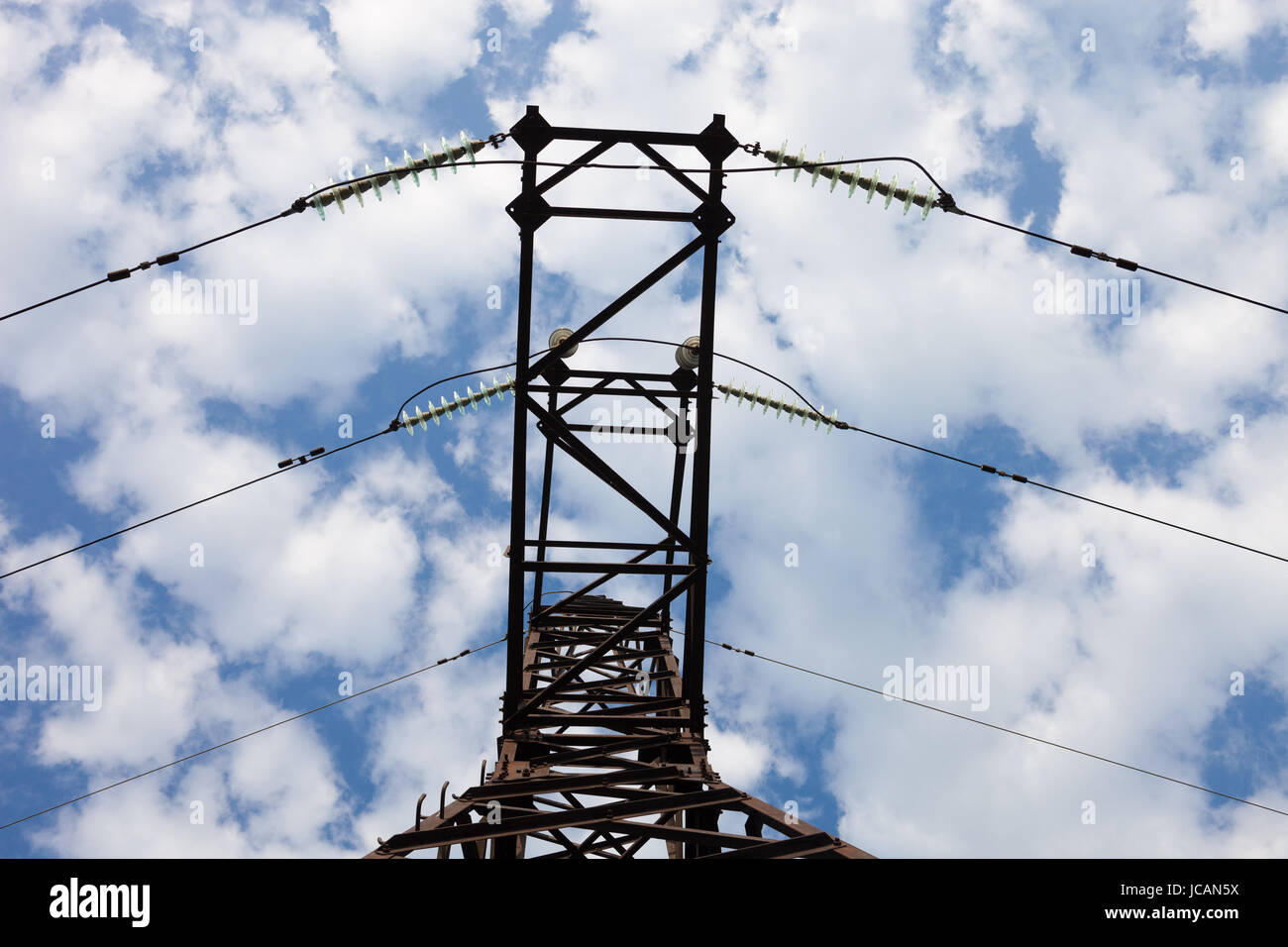 Electricity pylon against the cloudy sky background Stock Photo - Alamy
