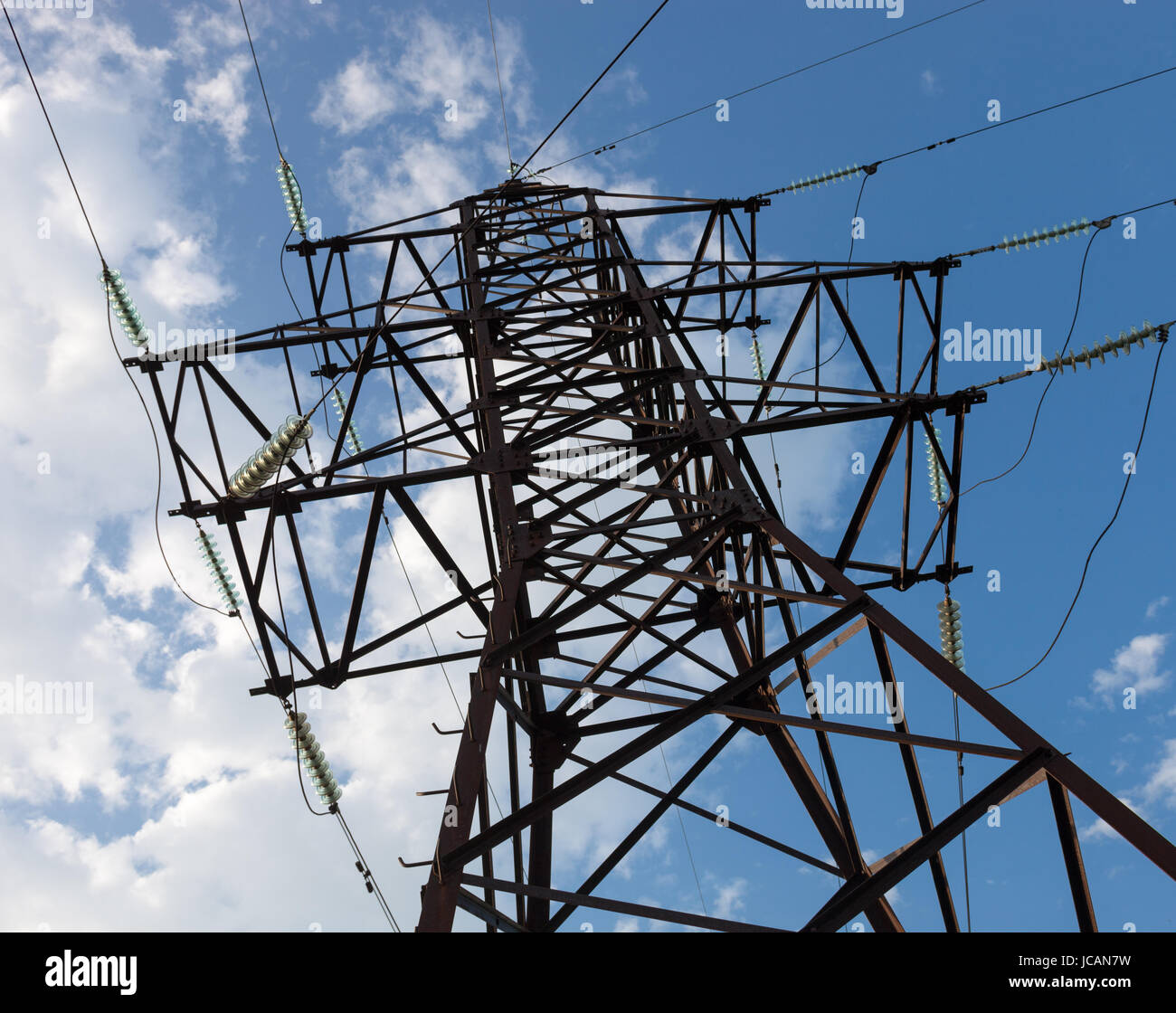 Electricity pylon against the cloudy sky background Stock Photo - Alamy