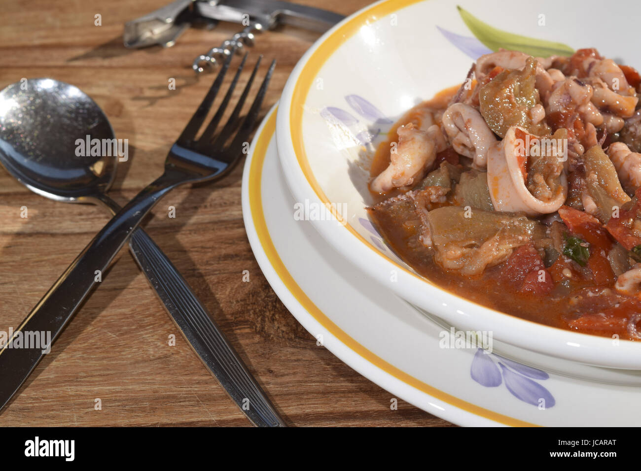 a typical italian recipe: soup of squid with tomato sauce Stock Photo