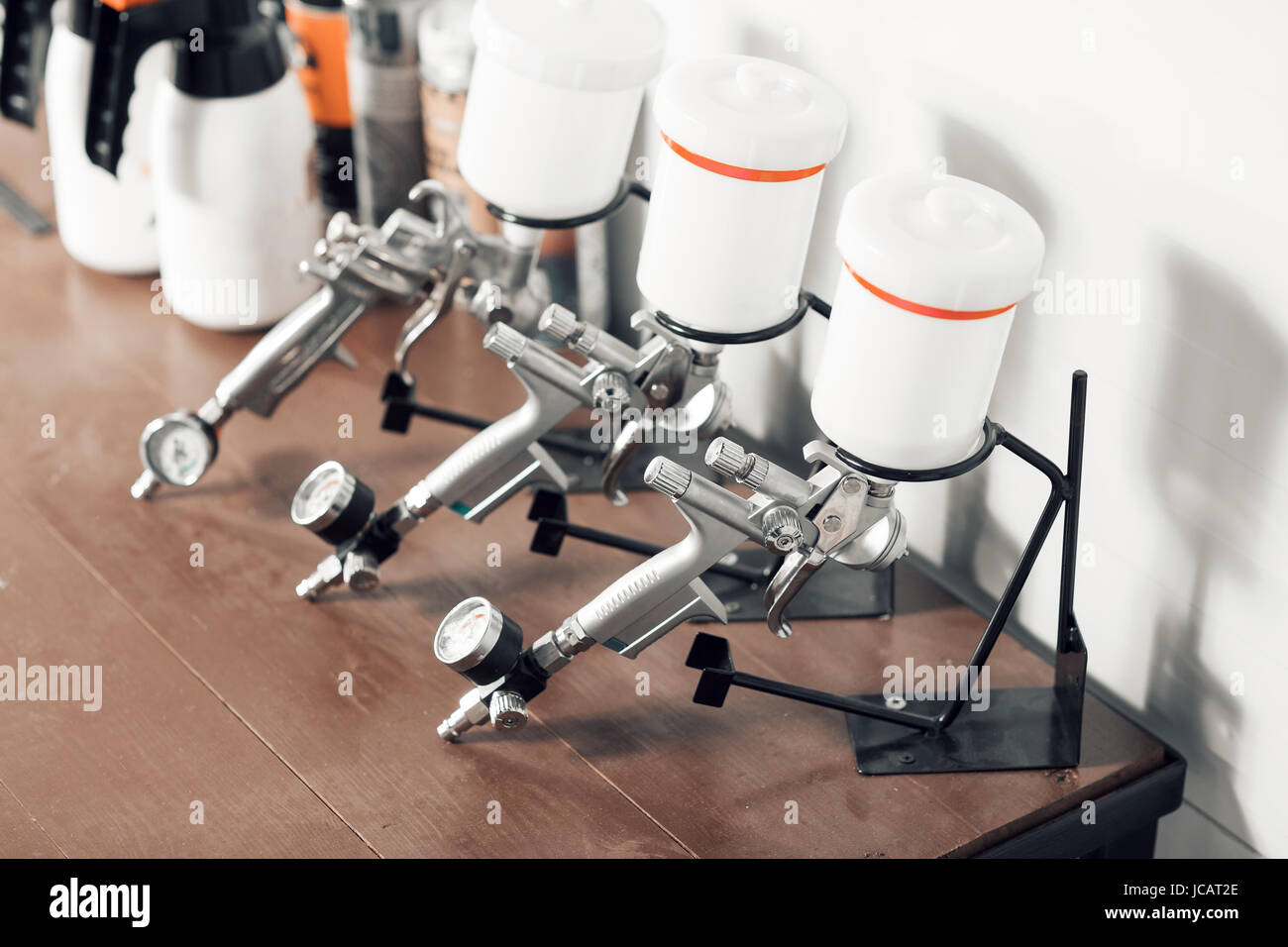 spray gun on wood table. in auto service. used for industrial painting