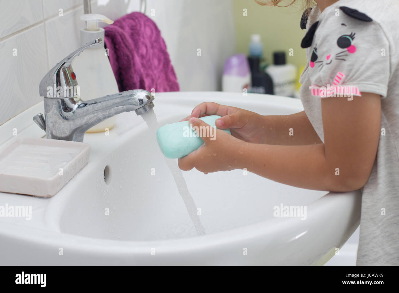 Little girl washing her hands in bathroom Stock Photo - Alamy