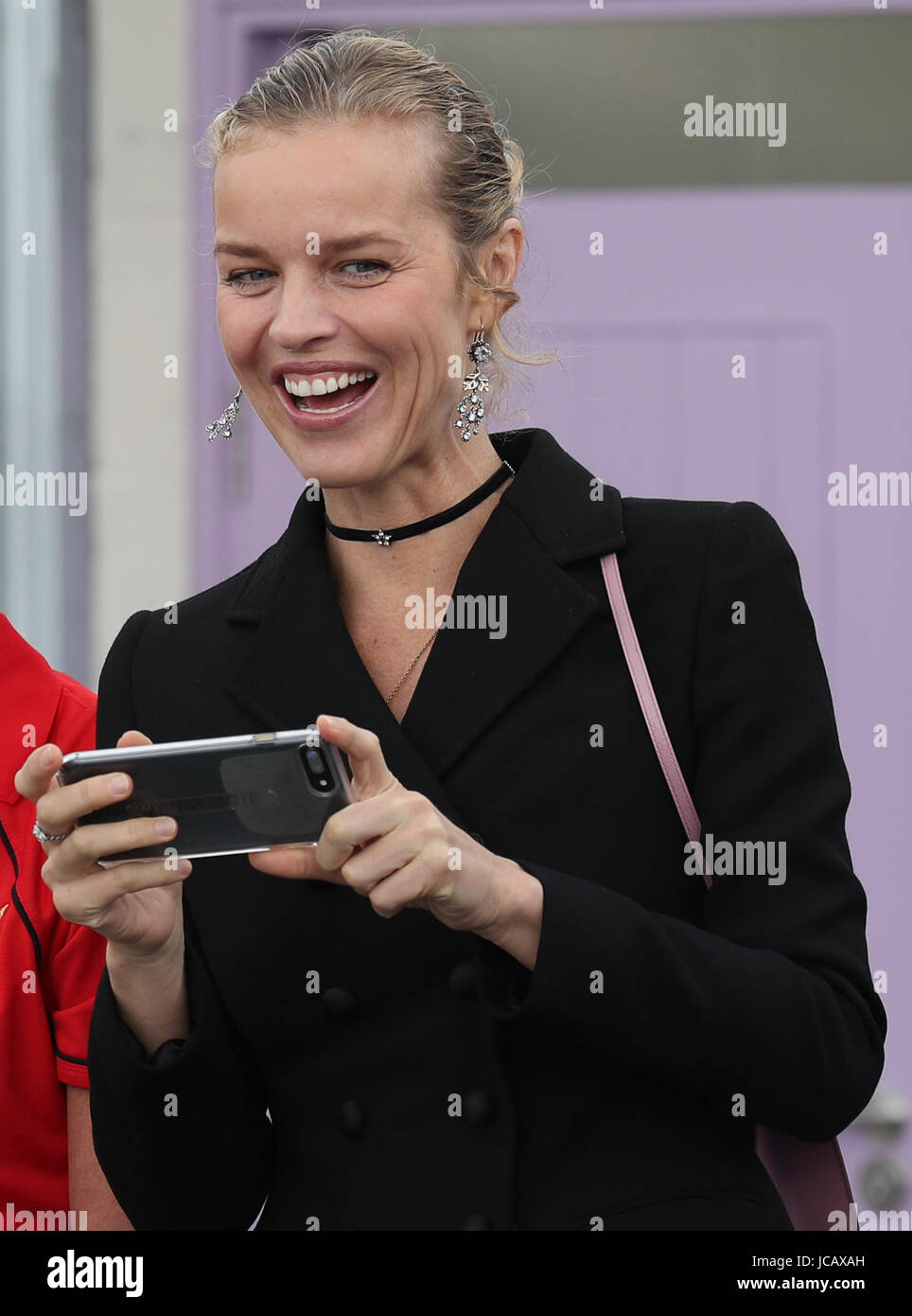 Model Eva Herzigova takes a picture on her phone as The Prince of Wales, known as the Duke of Rothesay officially opened the refurbished New Cumnock open-air swimming pool in East Ayrshire, which was saved from demolition. Stock Photo