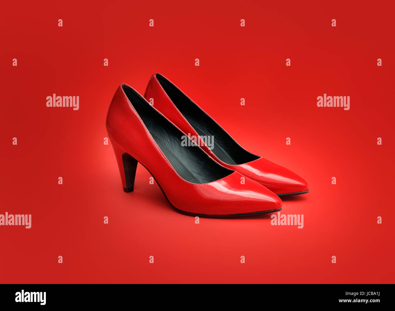 Pair of women's red pumps on red background. Stock Photo