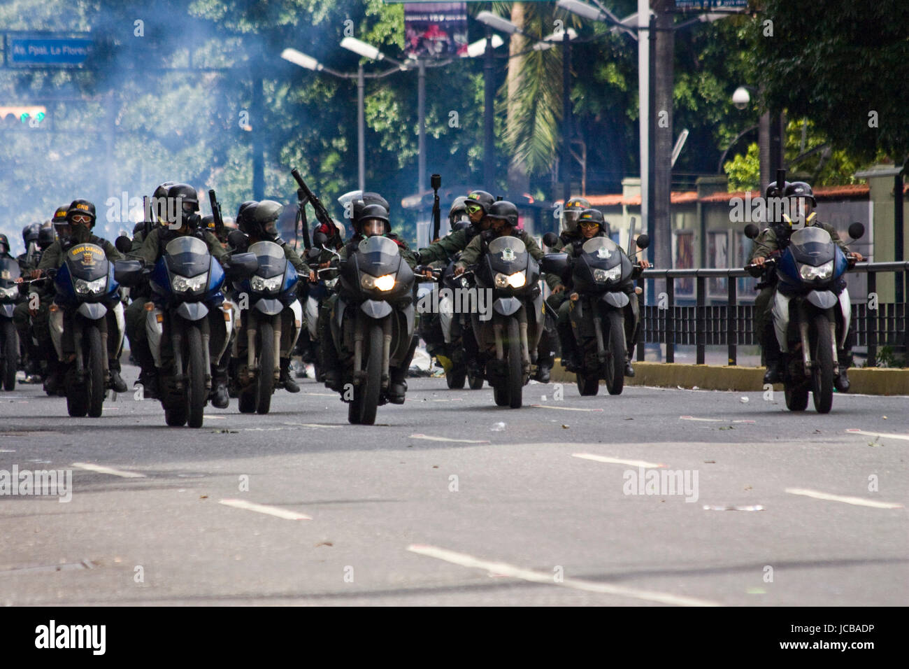 Members of the Bolivarian National Guard of Venezuela patrol a street after disperse a protest against the government of Nicolas Maduro. Stock Photo