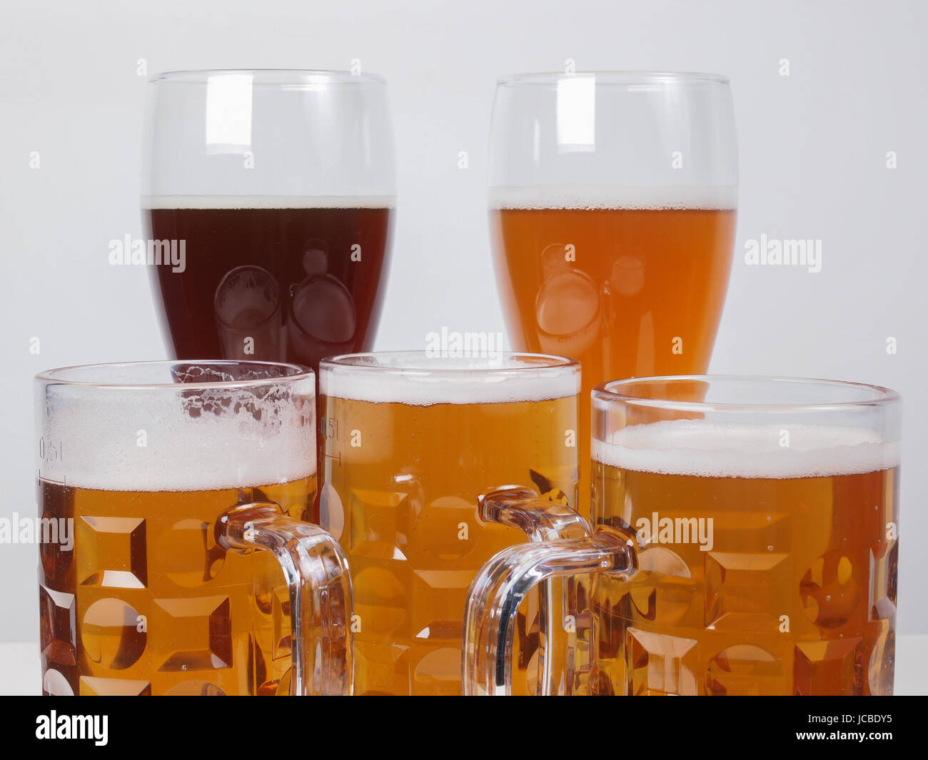 Many glasses of German beers including weiss dunkel and lager Stock