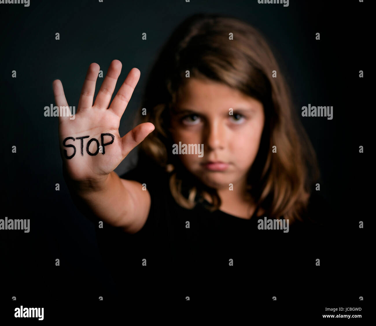 Angry girl, showing hand signaling to stop violence Stock Photo